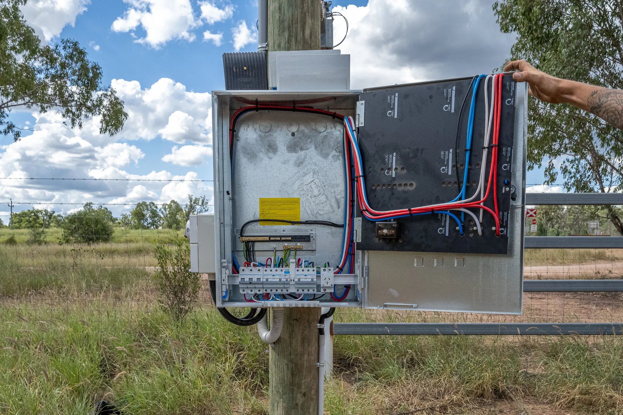 Rural switchboard installation under a clear Queensland sky.