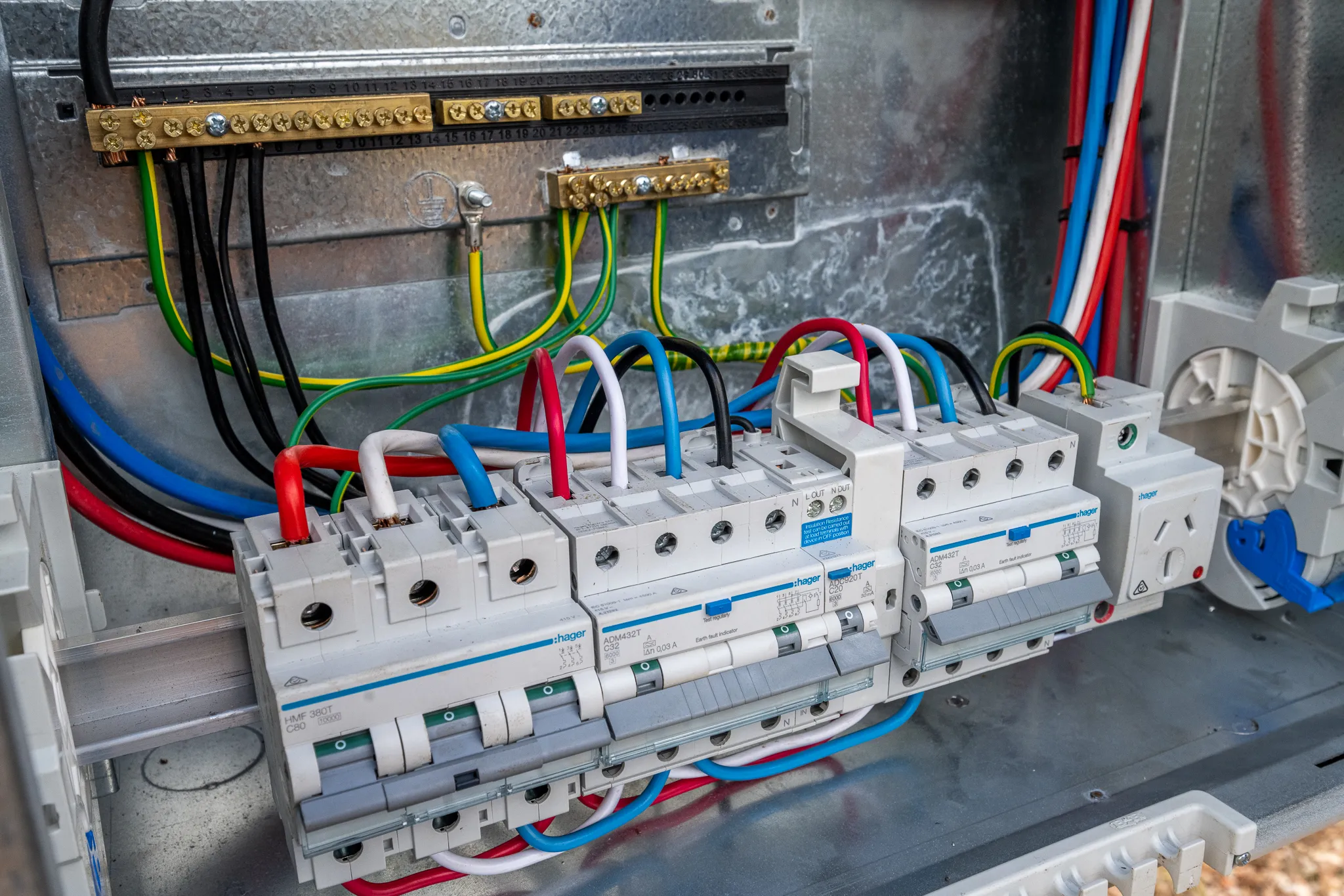 The inside of an upgraded switchboard, with the main switch, RCBOs and colour-coded circuit wiring on the din rail