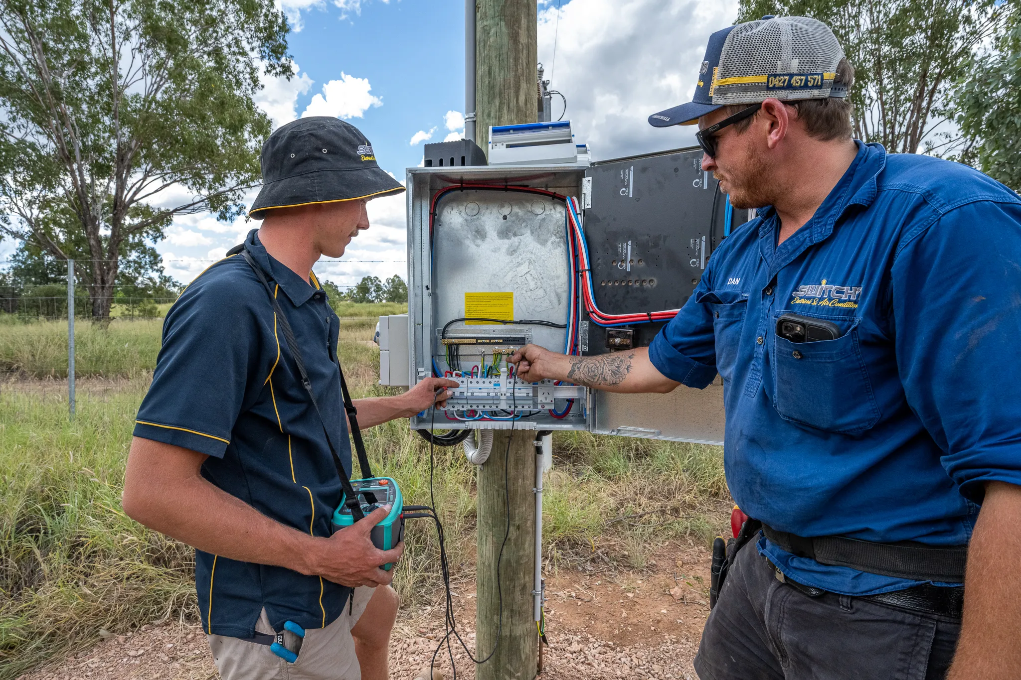 Two Switch'D electricians working on power infrastructure.