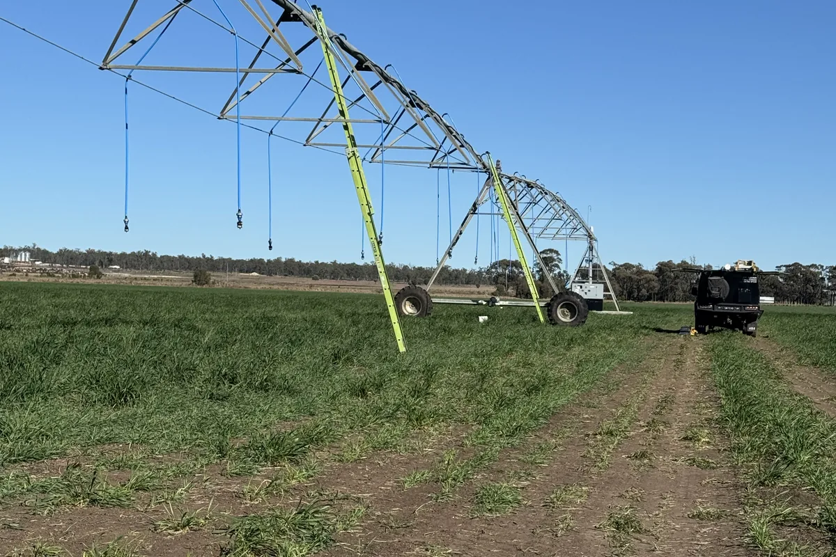 A centre-pivot span reaching across a green cropping paddock.