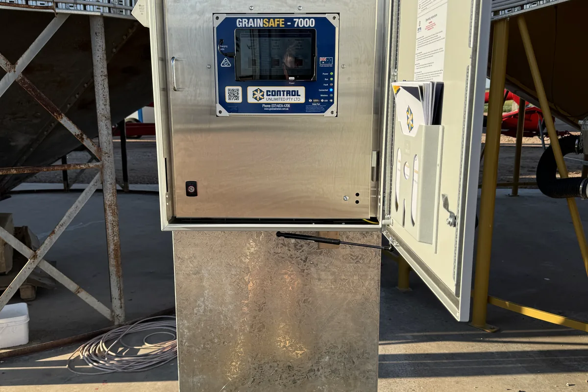 A GrainSafe 7000 grain monitoring controller in an open enclosure on a pedestal.