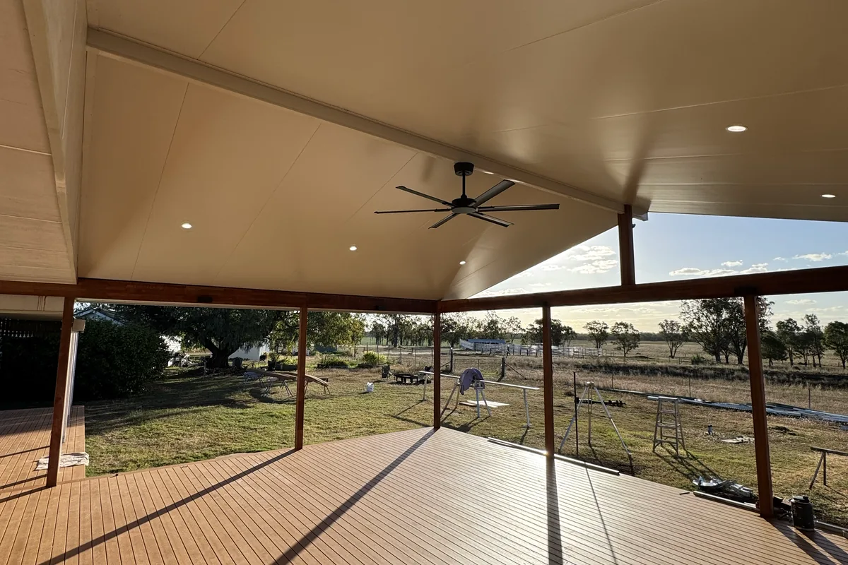 A covered outdoor entertaining area with ceiling fans and downlights