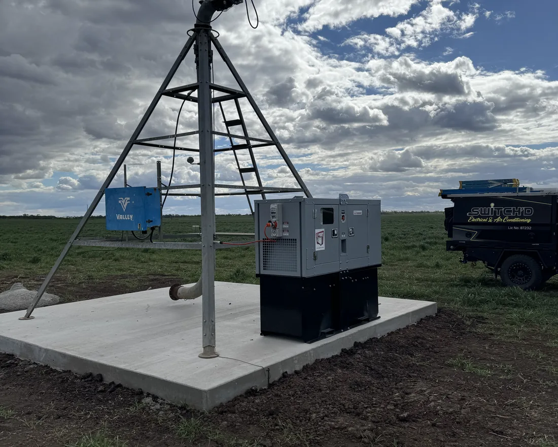 The head of a centre pivot with the pump control cabinet and switchboard installed on a concrete pad
