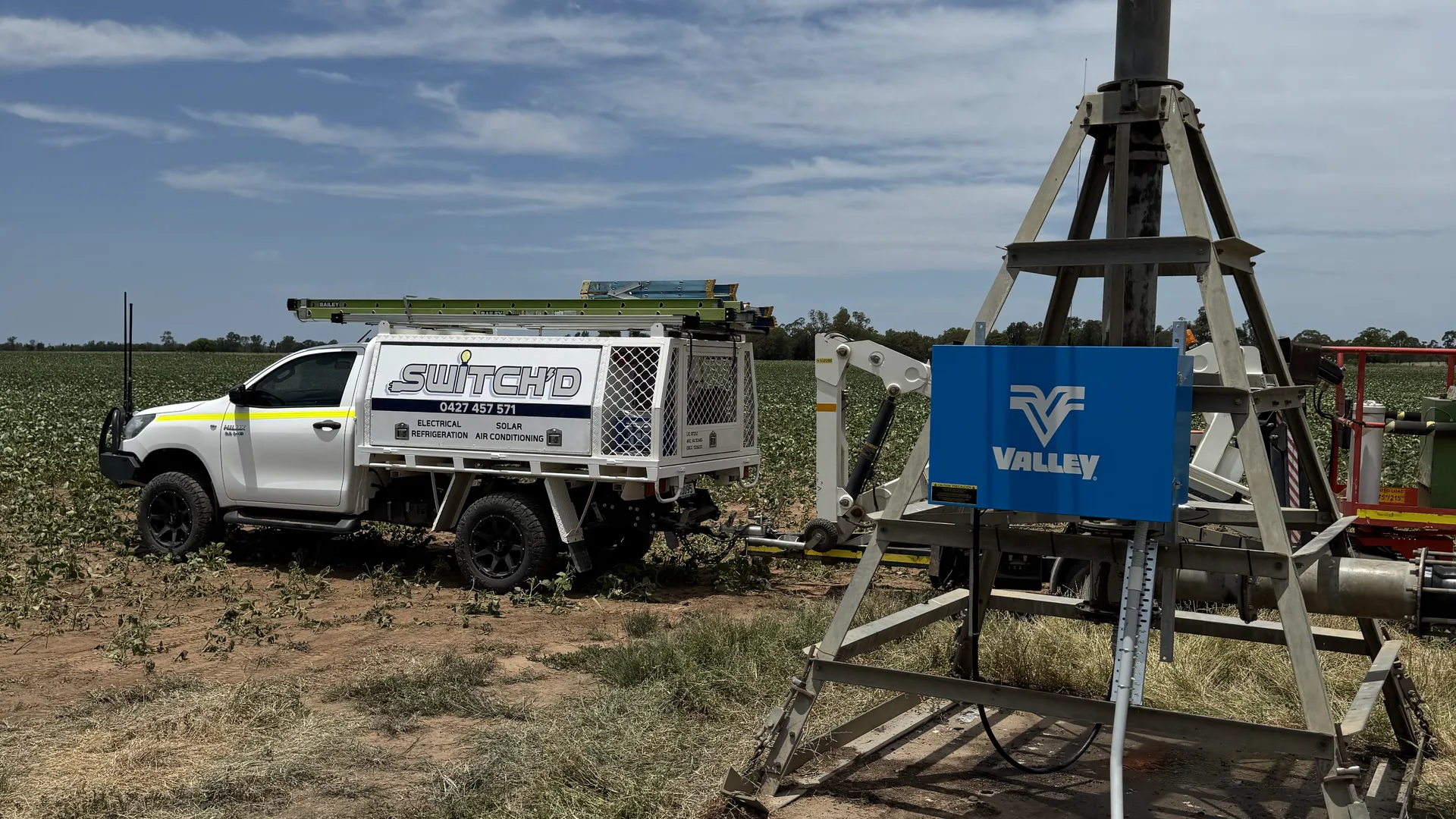 The Switch'D ute pulled up at a centre-pivot tower under heavy cloud on a Western Downs paddock