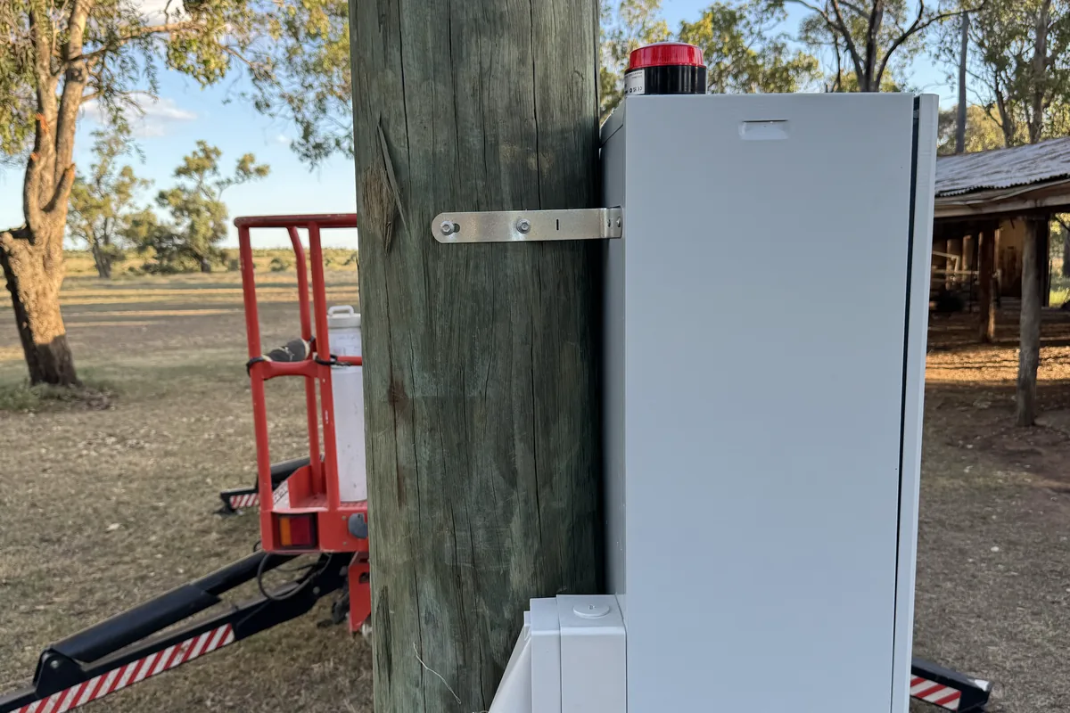 A pole-mounted enclosure with an external socket outlet, elevated work platform alongside.
